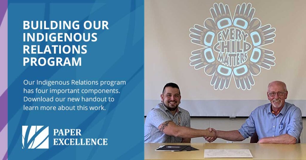 two men sitting next to each other shaking hands, acknowledging the Paper Excellence Indigenous Relations Program