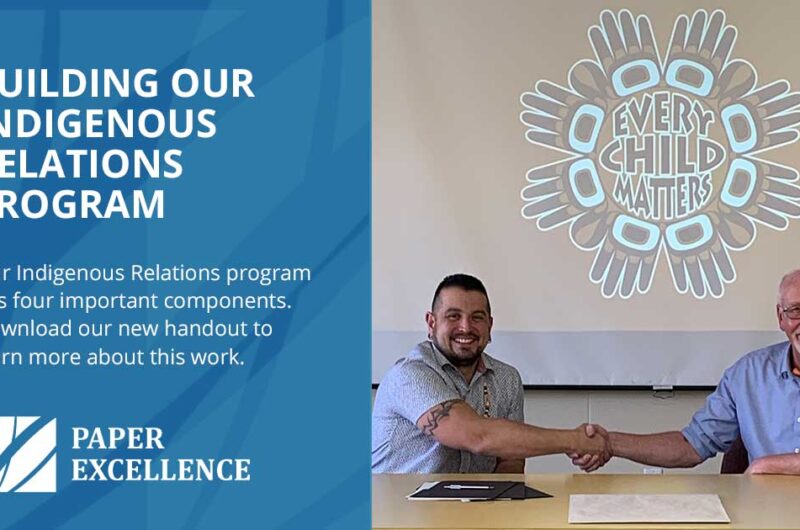 two men sitting next to each other shaking hands, acknowledging the Paper Excellence Indigenous Relations Program